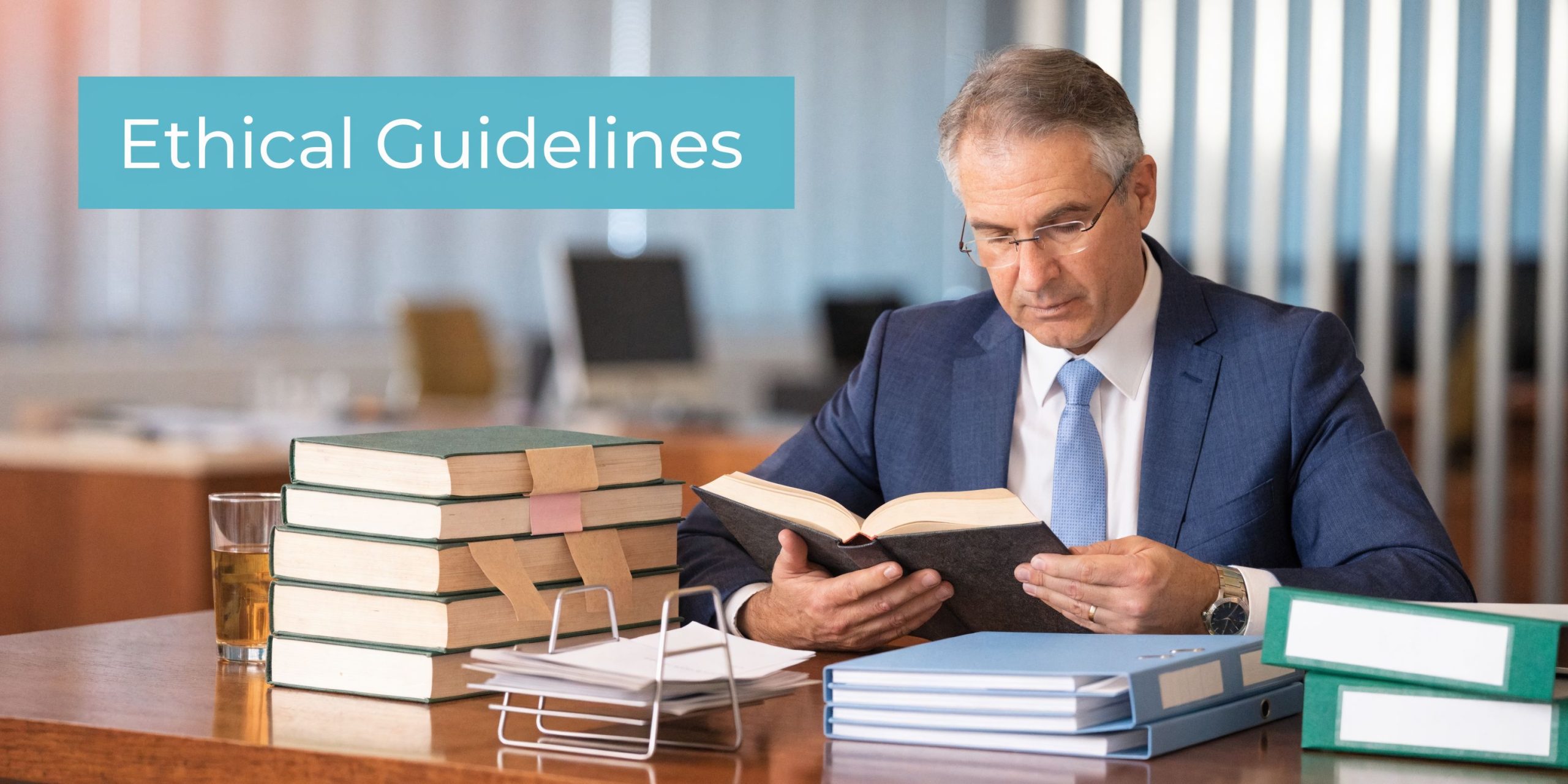 A professional attorney in a suit sitting at a desk reviewing legal textbooks and documents.