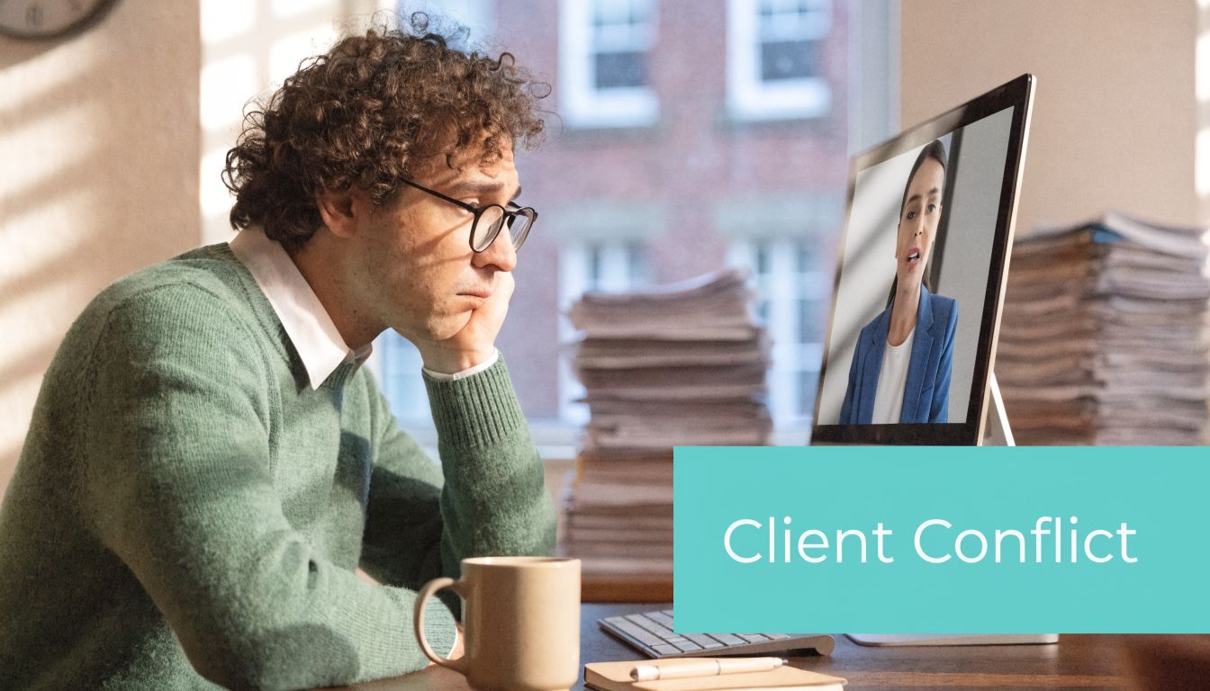 A man looking stressed while on a video call about client conflict with a colleague on screen.