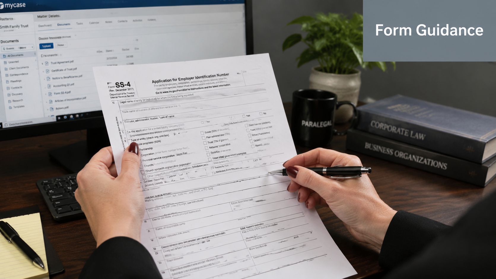 A professional holding an IRS Form SS-4 for business tax identification while working in an office setting.
